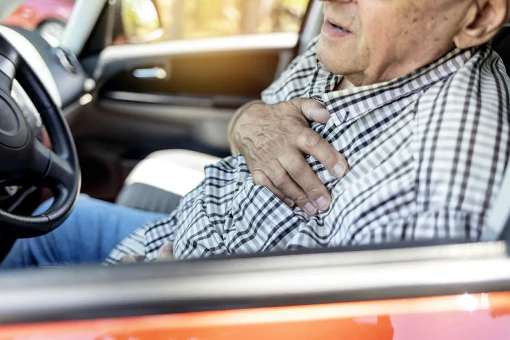 Man experiencing chest pain while driving, possibly due to traumatic aortic rupture from a car accident in Houston