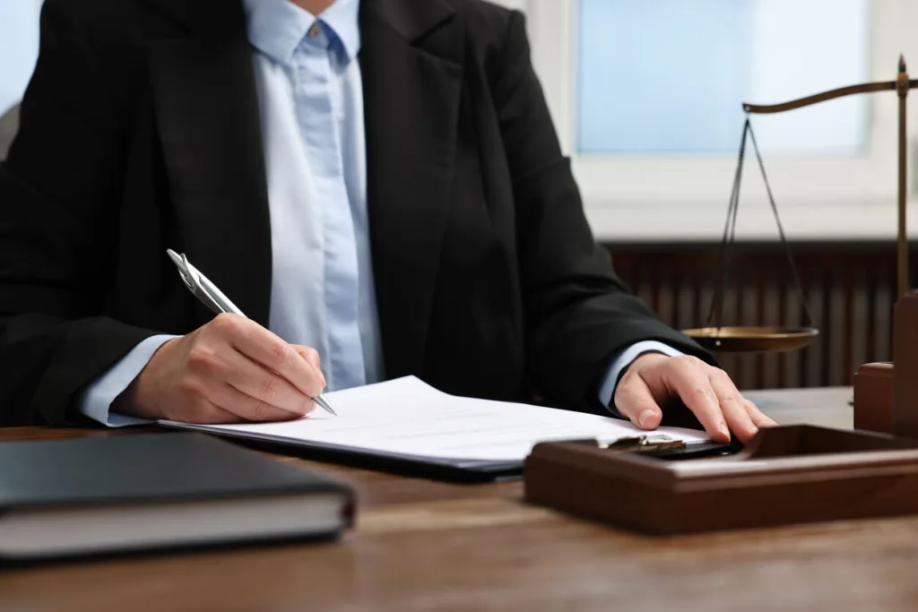 Lawyer is sitting on the table and writing 
