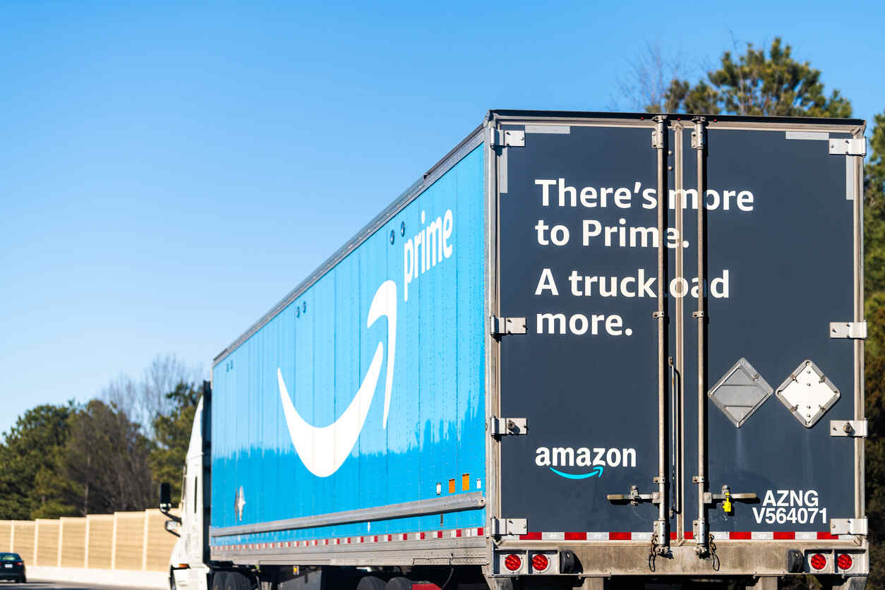 Amazon Prime truck with logo and slogan on a highway abouit what the image shows