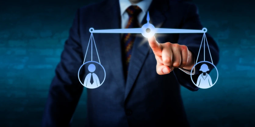 Balancing fairness: a digital scale with male and female figures, symbolizing legal liabilities in negligent hiring.