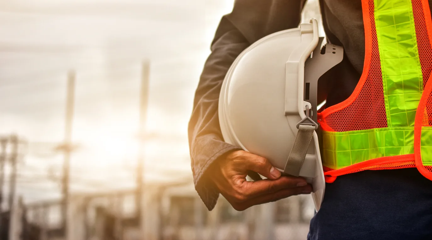 Technician holding white hat safety hard hat sunlight background - Industrial Workforce 